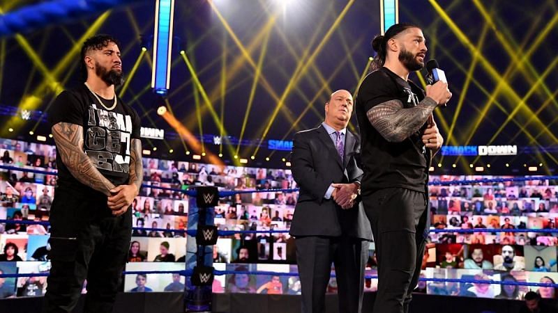 Paul Heyman (center) is Roman Reigns' special counsel